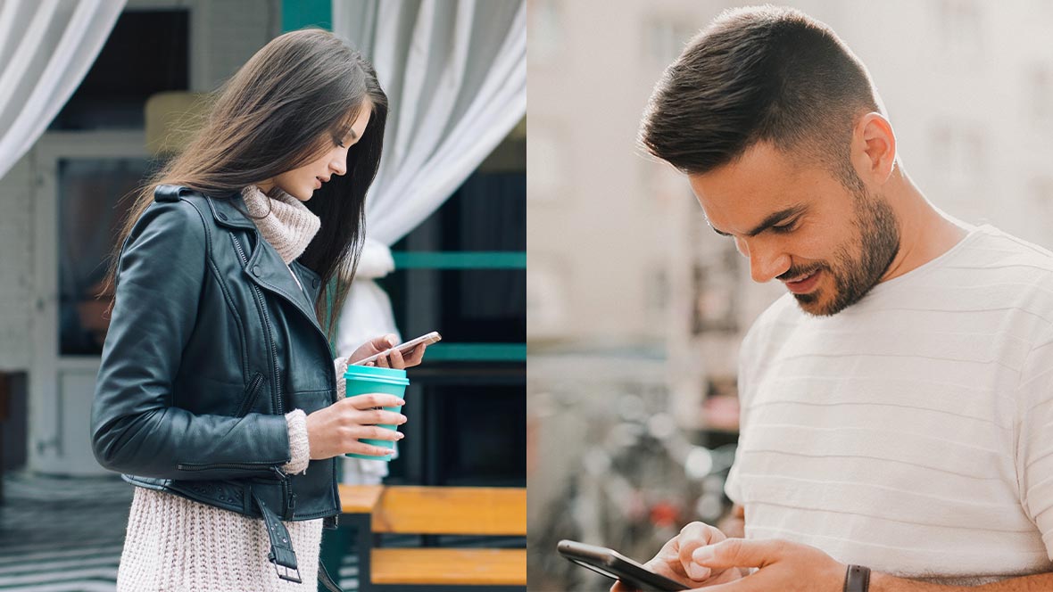 A man and a woman are looking at a smartphone.